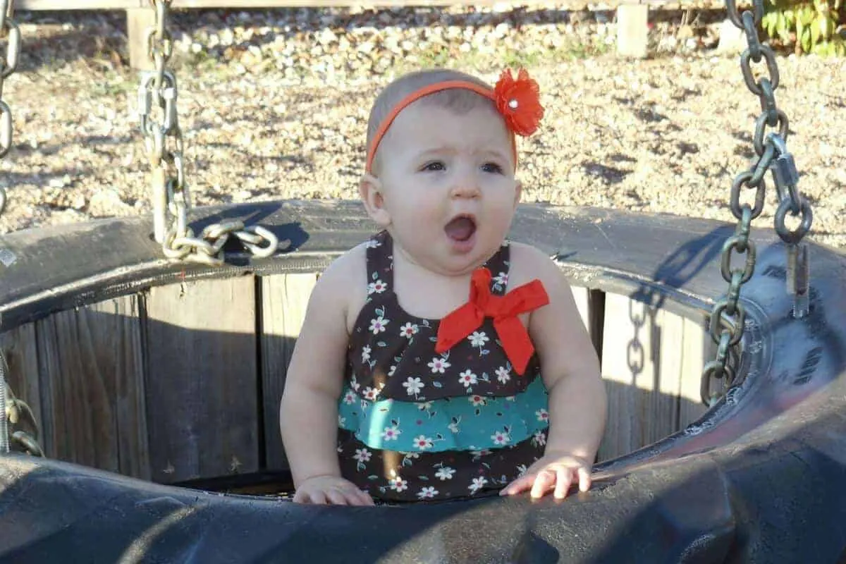 Baby in tire swing