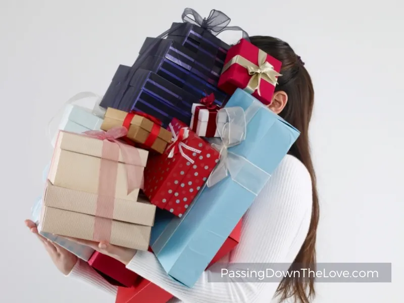 woman carrying stack of gifts