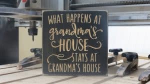 Wooden sign "what happens at Grandmas"