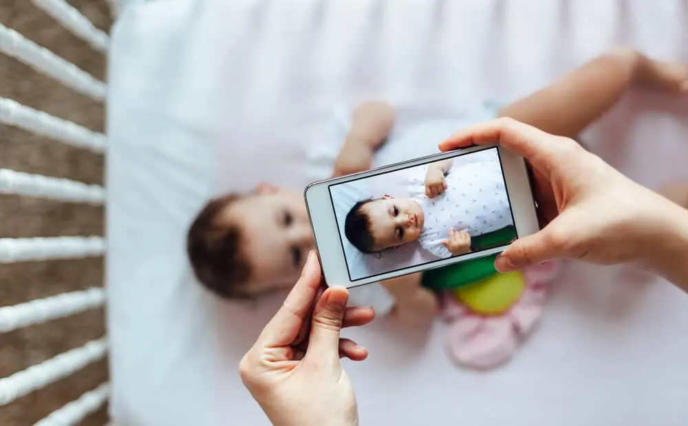 mom taking photo of baby