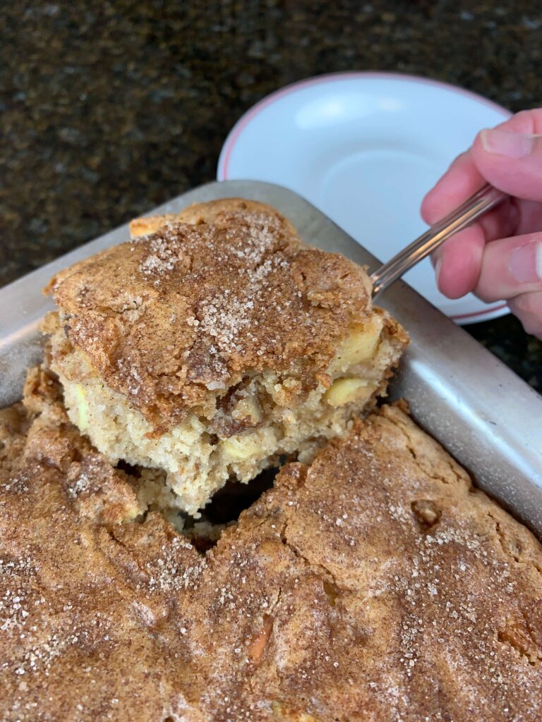 Taking a piece from Pan of Raw Apple Cake