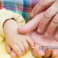 baby and grandparent hands