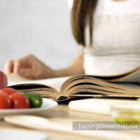 girl cooking with cookbook